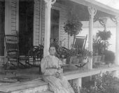Mrs. Cook and Polly parrot on the porch of the family home - Mulberry, Florida