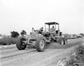Road grader on Subdivision Street - North Miami, Florida.