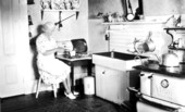 Mrs. Breen cutting bread in the kitchen - Pensacola, Florida.