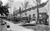 Men seated outdoors at the Antilla hotel - Coral Gables, Florida
