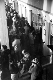 Men placing racing bets at the windows - Hialeah, Florida