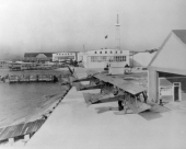 Three Curtiss airplanes by hangars - Pensacola, Florida.