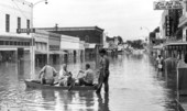 Photographers in boat on flooded street after Hurricane Dora - Live Oak, Florida