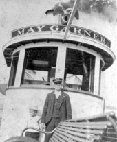 Captain Henry D. DeGrove with his son, Henry Jr., standing in front of the pilot house of the "May Garner" - Jacksonville, Florida