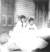 Myrta Maxon and Mrs. Roland reading on the back porch - Saint Andrews, Florida