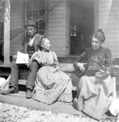 Mr. and Mrs. Maxon on the front porch of their home with Mrs. Roland - Saint Andrews, Florida