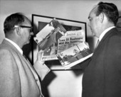 Representatives looking at photographs of Boulougne and news headline mentioning its demise - Tallahassee, Florida.