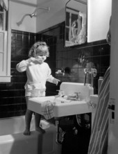 Unidentified child brushing her teeth at George Brunette's School of Art - Jacksonville, Florida.