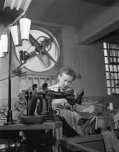 Woman assembling shirts in the sewing room