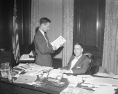 Governor Charley Johns with an artist sketching his portrait.