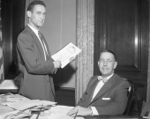 Governor Charley Johns with an artist sketching his portrait.