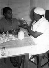 Midwife being instructed on infant care.