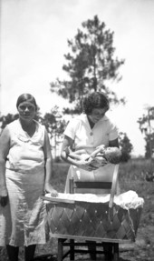 Public health nurse with mother and child.