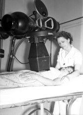 Expectant mother being x-rayed by a public health nurse.