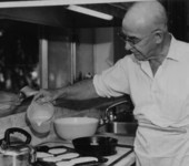 E. Harris Drew cooking pancakes.