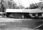 Unidentified girls playing badminton beside the lodge - Rainbow Springs, Florida