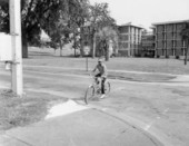 Bicyclist at a curb crossing near campus
