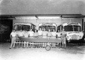 Drivers stand in front of Sunbeam trucks