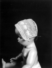 Antique handmade baby bonnet on a model