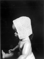 Antique handmade baby bonnet on a model