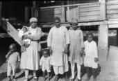 Family standing in front of their house