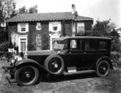 Rolls Royce in front of a house.
