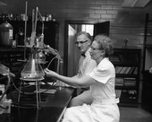 Director John Thompson watching chemist Bertha Munks test food in Tallahassee, Florida.