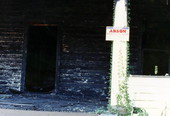View showing a fire damaged house with an arson sign posted - Tallahassee, Florida.