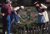 Costumed reenactors demonstrating traditional farming to visitors at the historic Mission San Luis site in Tallahassee, Florida.