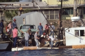 Men baling water out of a sunken boat in Carrabelle, Florida.
