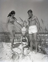 Eddie Allsopp and Eugenia Rossingnal modeling bathing suits with a boy at Daytona Beach.