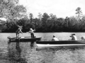 Movie camera operators filming fishing in the Suwannee River .