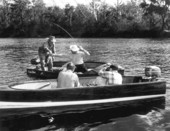 Movie camera operators filming fishing in the Suwannee River .