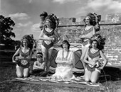 Young women pose in front of a fort for the premiere of the movie "Distant Drums" - Saint Augustine, Florida