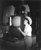 Unidentified woman posing with television during the 1955 Tupperware "Jubilee" - Orange County, Florida