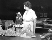 Unidentified woman with display of handmade rag dolls - Miami, Florida
