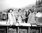 Women show materials made from ramie on a loom - Miami Beach, Florida
