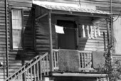Laundry hanging on clothes line from second story apartment on Whitehead and Fleming streets, Key West, Florida.