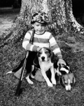 Young boy with hunting dog puppies