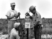 Richard McClelland and two men put up a sign