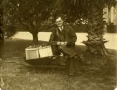 Governor John Martin peels an apple under the trees